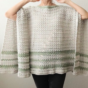 May include: A crocheted poncho with a white and green striped pattern. The poncho has a wide, open neckline and a loose fit.