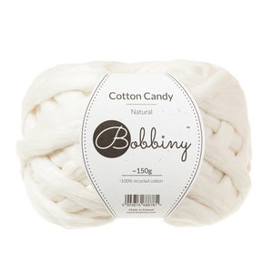 May include: A white ball of Cotton Candy yarn by Bobbiny, made from 100% recycled cotton. The label says "~150g" and "Natural".