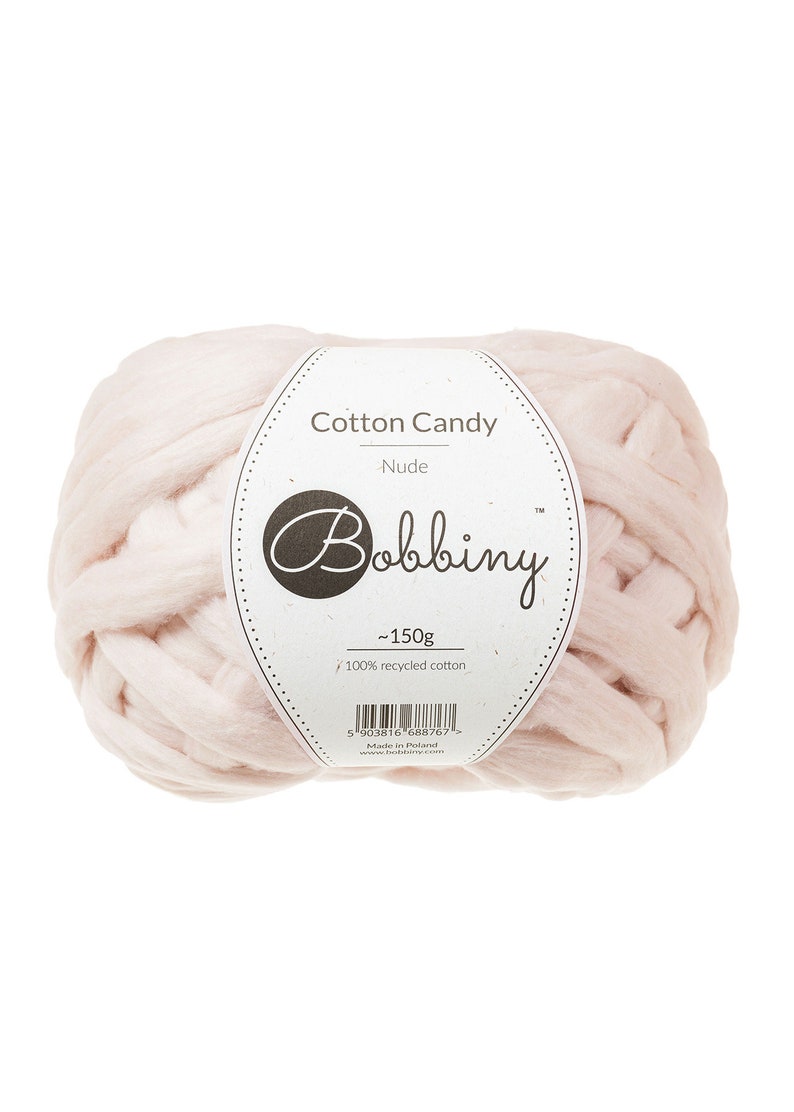 May include: A ball of pale pink yarn labeled "Cotton Candy - Nude" by Bobbiny. The label also states "~150g" and "100% recycled cotton".
