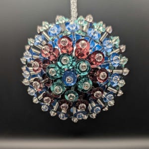 May include: A set of three ceramic mugs with a speckled, matte finish. The mugs are in shades of cream, light gray, and dark gray. Each mug has a simple, minimalist design and a rounded handle. The mugs are likely for coffee or tea.