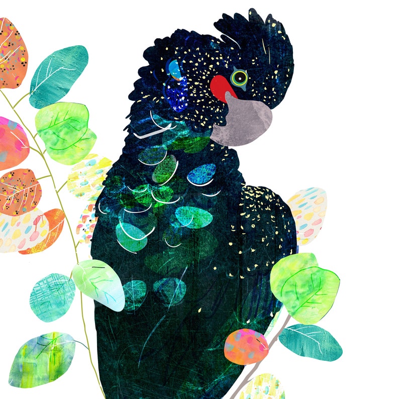 May include: A black cockatoo with a red and green eye perched on a branch of green leaves with colorful accents.