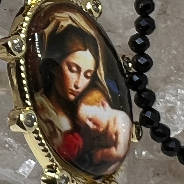 Tiny onyx faceted beads, gold filled beads hold this beautiful pendant picture of Mother and Child.  A very beautiful necklace, meaningful.