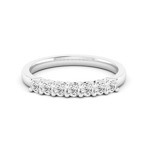 May include: A silver band ring with six small round diamonds set in a row.