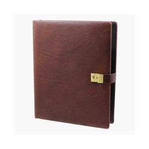 May include: A brown leather-bound journal with a brass lock and clasp. The journal has a textured surface and a dark brown color.