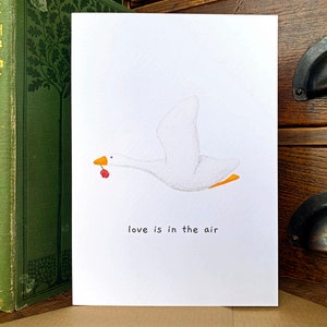 Liefde hangt in de lucht relatiekaart, wenskaart schattige dieren gekke gans, schattige gans liefdeskaart voor koppels, John Paul Young-kaart