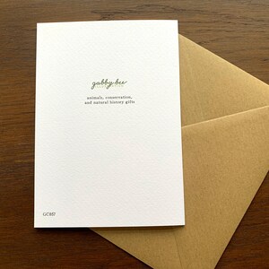May include: A white card with the text "gabby bee illustration" and "animals, conservation, and natural history gifts" printed in green. The card has the number "GC057" printed in black in the bottom right corner.