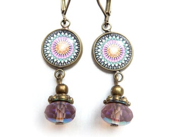 Bronze-colored cabochon earrings with Mandala in various colors and a pink faceted glass bead