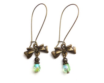 Bronze-colored earrings with XL ear hooks, a bow and light green glass facet beads