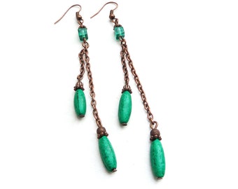 Copper-colored earrings with wood and glass beads in emerald green