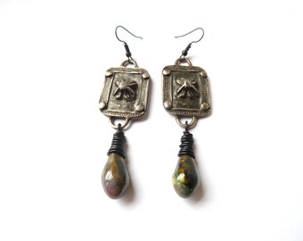 Earrings with antique silver-colored ornaments and a glazed ceramic pendant