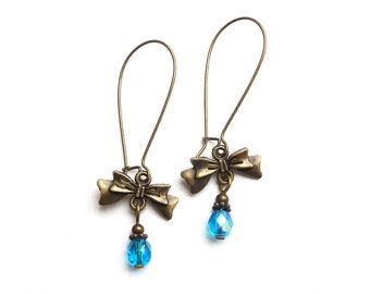 Aqua blue faceted glass beads on bronze-colored earrings with XL ear hooks and a beautiful bow