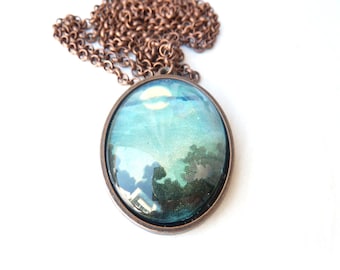 Copper-colored necklace with an antique illustration from the early 1900s of a mysterious moon at night