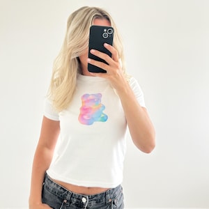 May include: White cropped t-shirt with a rainbow gummy bear graphic.