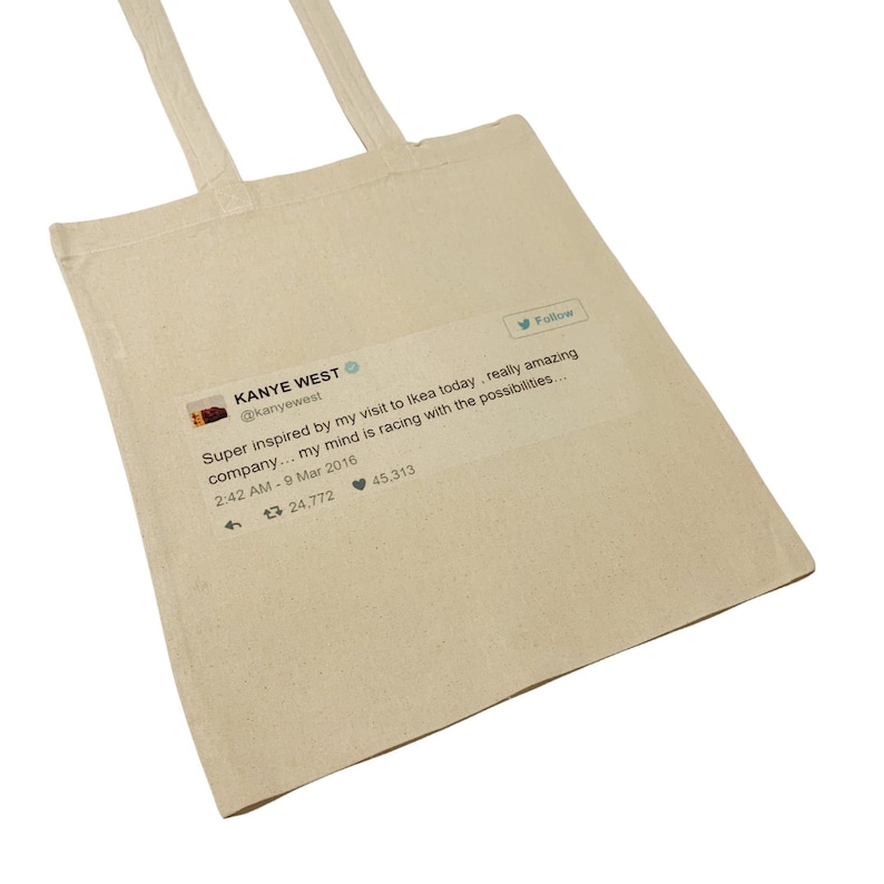 May include: A white canvas tote bag with a printed image of a tweet from Kanye West. The tweet reads: "Super inspired by my visit to Ikea today, really amazing company... my mind is racing with the possibilities..." The tweet was posted on March 9, 2016, and has 24,772 retweets and 45,313 likes.