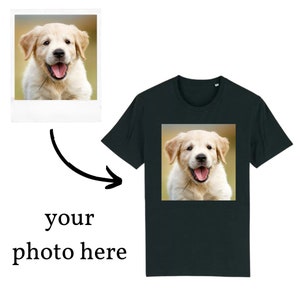 May include: A black t-shirt with a photo of a golden retriever puppy on the front. The puppy is looking at the camera and has its tongue sticking out.