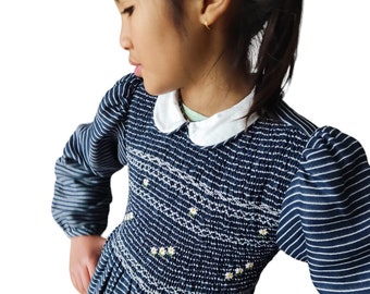 Smocked dress with loose sleeves. Navy blue striped smocked dress. Girls' smocked dress. Smocked dress with peter pan collar