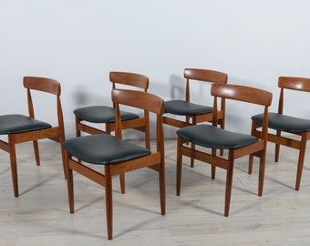 May include: Set of six mid-century modern dining chairs with dark wood frames and black upholstered seats.