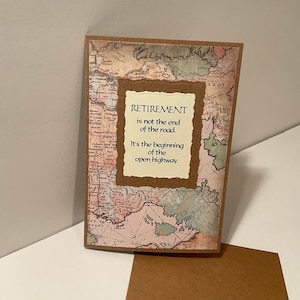 May include: A card with a vintage map background and a quote about retirement. The quote reads "Retirement is not the end of the road. It's the beginning of the open highway."