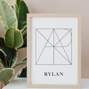 May include: A framed print featuring a geometric design in black lines on a white background. The name "RYLAN" is printed below the design.