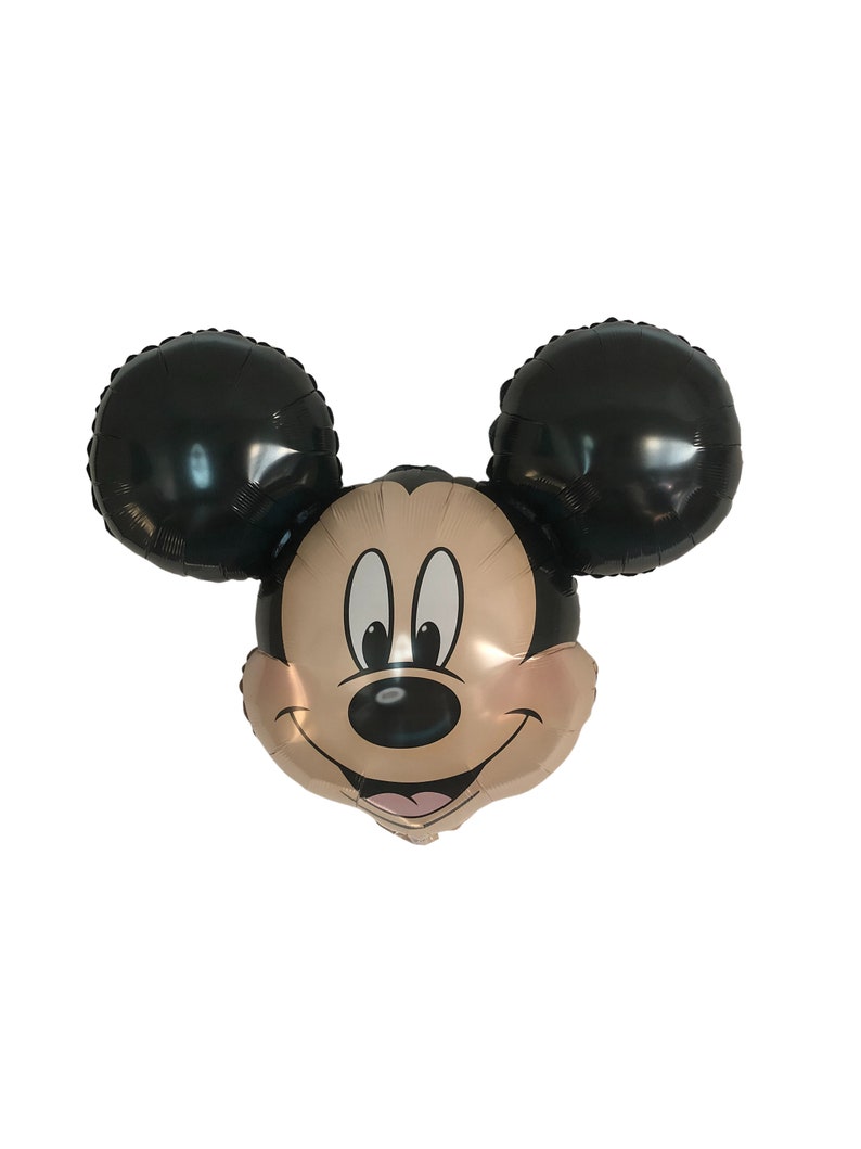 May include: A black and gold Mickey Mouse balloon with a smiling face. The balloon is shaped like Mickey Mouse's head with large black ears.