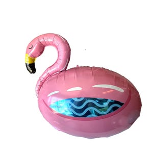 May include: Pink flamingo-shaped balloon with a yellow and black beak. The balloon has a smiling face design with a blue and white wavy pattern inside the mouth. A fun decoration for parties and events.