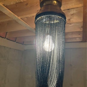 Light fixture/ Chain Chandelier in Gold & Black   Unique and striking light fixture/ chandelier. Gold base with black chain features.