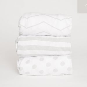 May include: Three gray sheet sets stacked on top of each other. The top sheet has a chevron pattern, the middle sheet has stripes, and the bottom sheet has polka dots.