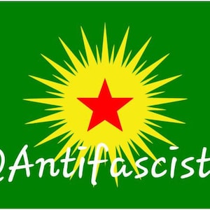 May include: A green flag with a yellow sunburst and a red star in the center. The text "@Antifa" is written in white at the bottom of the flag.
