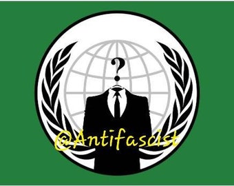 May include: A green flag featuring a white circle with a black silhouette of a suit and tie, a question mark for a head, and a globe. The text "@Antifascist" is written in yellow.