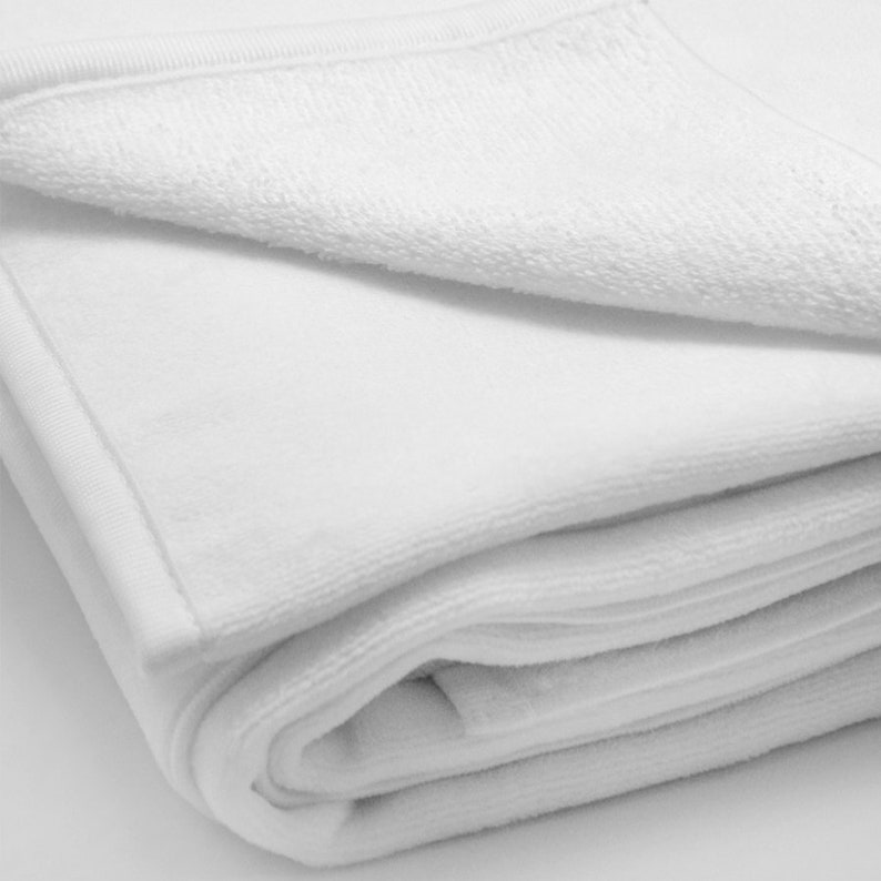 May include: A white plush blanket folded in thirds, showing the soft, fluffy texture of the fabric.