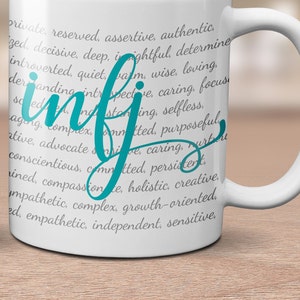 May include: White ceramic mug with a teal blue inscription that reads "infj" and a list of personality traits associated with the Myers-Briggs personality type.