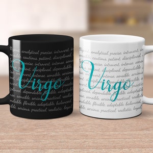 May include: Two ceramic coffee mugs with black and white backgrounds. The mugs feature the word "Virgo" in teal text surrounded by a list of personality traits.
