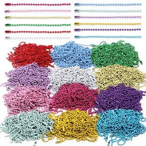 May include: A collection of multi-colored ball chains, featuring individual strands in red, pink, yellow, green, white, light blue, lavender, and purple. Below the strands are large, loose piles of matching colored ball chains.
