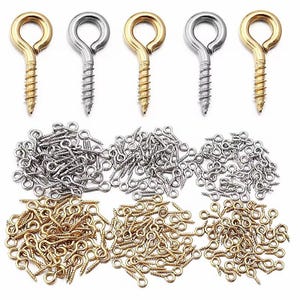 May include: A selection of eye screw hooks in gold and silver. The image displays multiple rows of the screw hooks, with varying sizes and quantities. These hooks are suitable for a range of crafting and DIY projects.