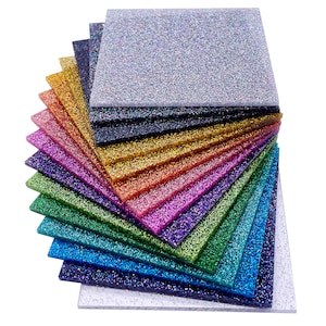 May include: A stack of 12 iridescent glitter sheets in various colors, including silver, gold, red, purple, green, blue, and black. The sheets are arranged in a fan shape, with the silver sheet at the top and the black sheet at the bottom.