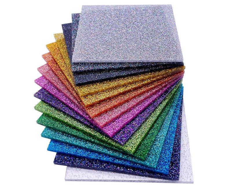 May include: A stack of 12 iridescent glitter sheets in various colors, including silver, gold, red, purple, green, blue, and black. The sheets are arranged in a fan shape, with the silver sheet at the top and the black sheet at the bottom.