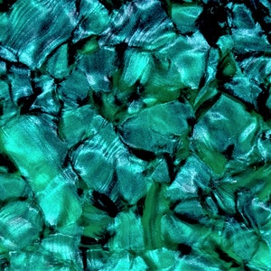 Puede incluir: Primer plano de un material verde azulado iridiscente con una superficie texturizada y agrietada.