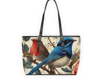 May include: A tote bag featuring a vintage-style illustration of two birds perched on a branch with flowers. The bag has black handles and trim, with a cream-colored background. The birds are a vibrant red and blue.
