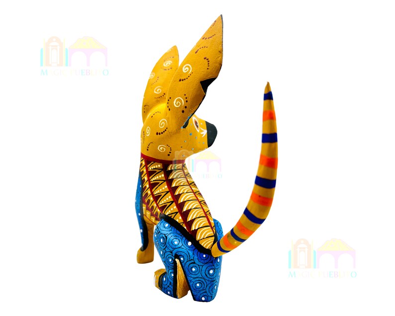 May include: A hand-painted wooden dog figurine with yellow, blue, orange, and red details. The dog is sitting with its tail curled up. The figurine is a traditional Mexican folk art piece.