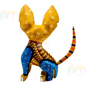 May include: A hand-painted wooden sculpture of a dog with large ears. The dog is painted in shades of yellow, blue, orange, and brown. The sculpture is a traditional Mexican folk art piece.