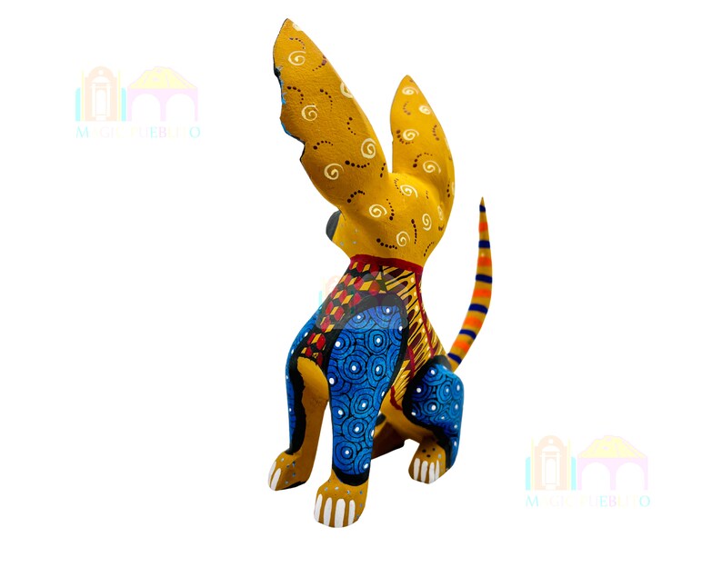 May include: A hand-painted wooden dog figurine with yellow, blue, red, and orange colors. The dog is sitting with its tail curled up and its ears perked up. The figurine is a traditional Mexican folk art piece.