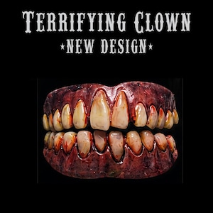 May include: A set of prosthetic teeth featuring a dark red, textured gum line and stained, yellowed, uneven teeth. The text TERRIFYING CLOWN NEW DESIGN is printed in white above the dental appliance against a solid black background.