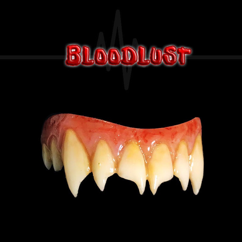 May include: A set of vampire fangs with a red and yellow gum line, and sharp, pointed teeth. The word "BLOODLUST" is displayed in red, 3D lettering above the fangs against a black background. A graphic of a heartbeat is behind the text.