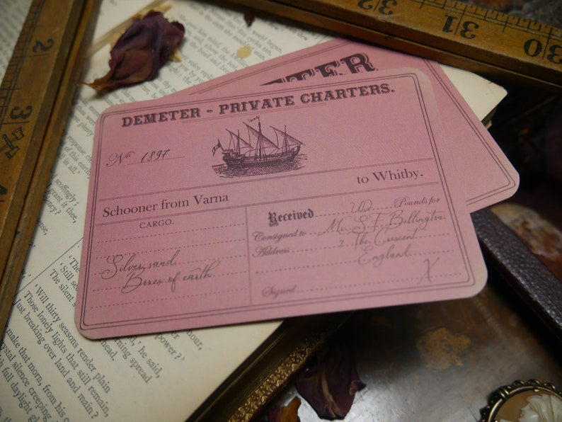 May include: A pink shipping label for the Demeter Private Charters company. The label is numbered 1897 and lists the cargo as "Silvy sand... Beres of caith..." The label is addressed to Mrs. S.F. Billington in The Crescent, England.
