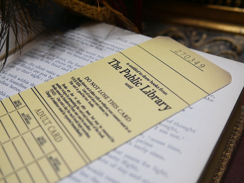 May include: A yellow library card with the text "The Public Library" and the number "270349". The card states that the holder is entitled to draw books from the library until a certain date. The card also has a section for an adult card with columns for date, returned, date, and returned.