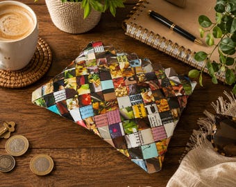 May include: A rectangular pouch constructed from woven strips of colorful magazine paper featuring various food imagery and printed text. The surface displays a grid pattern of small squares in shades of red, green, yellow, and white, creating a textured appearance.