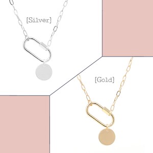 May include: Two silver and gold necklaces with a carabiner clasp and a round pendant. The silver necklace has the text [Silver] and the gold necklace has the text [Gold].