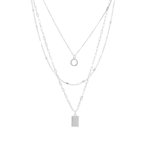May include: A silver layered necklace with a circle pendant and a rectangular pendant.