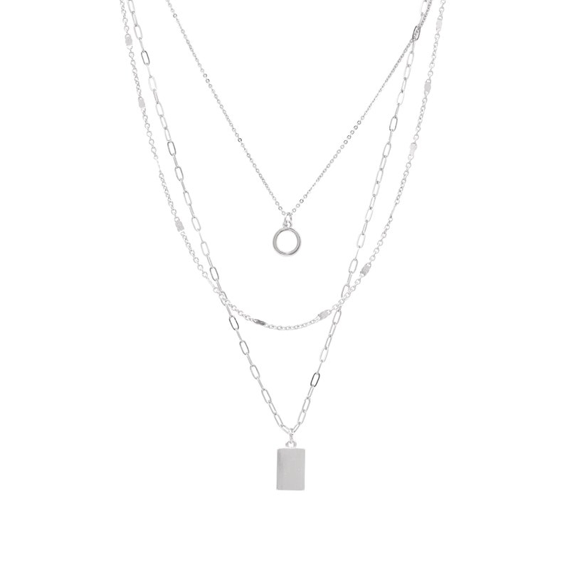 May include: A silver layered necklace with a circle pendant and a rectangular pendant.