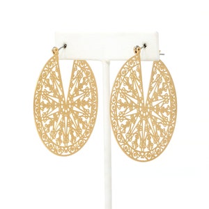 A pair of lightweight filigree statement hoop earrings in gold.